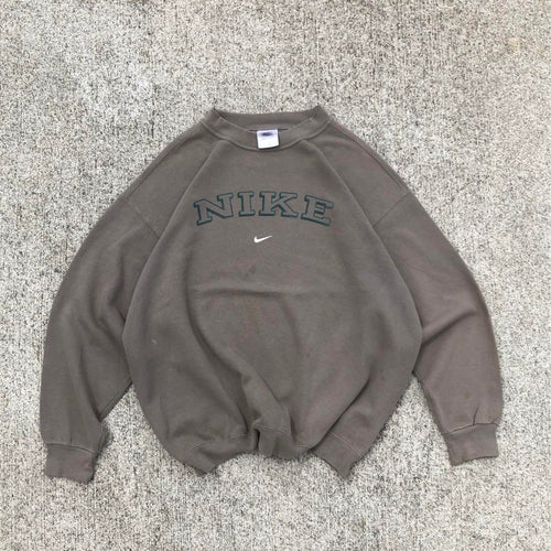 90s USA-made sweatshirt with a faded center logo by Stussy Oakley.